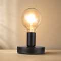 Lexion Bulb industrial table lamp on a clean warm premium background