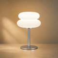 Lexion Cream soft glow table lamp on a clean warm premium background