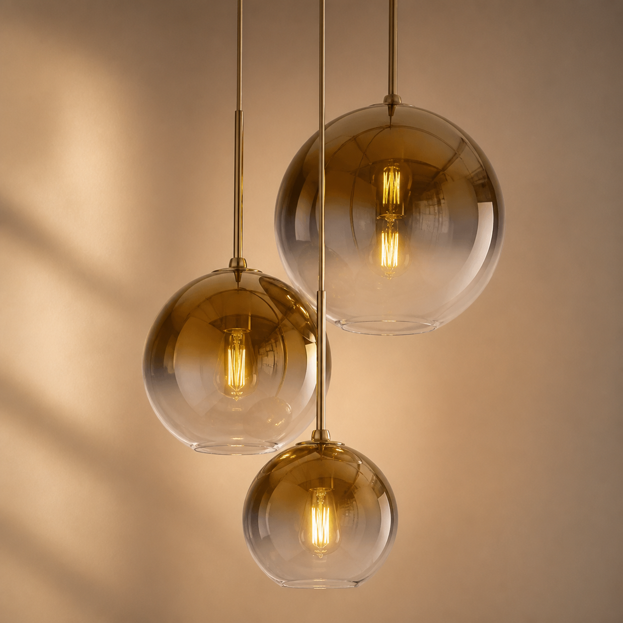 Lexion Mirra three-globe glass pendant light on a clean warm premium background