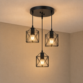 Lexion Triad three-light metal pendant fixture on a clean warm premium background